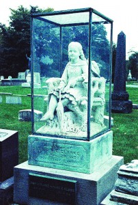 The statue of Inez Clarke, a young girl killed by a lightning strike, at Graceland Cemetery. Many visitors to the cemetery claimed they have seen a young girl playing near the statue. (Giovanni Lenski / The DePaulia)