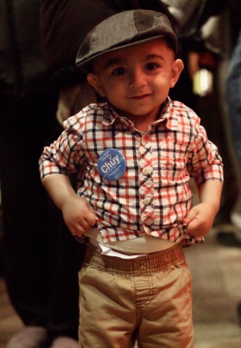 One and a half-year-old Azan joined his father Assad Saadat at Jesus "Chuy" Garcia's election night event on Feb. 24. Supporters passed out buttons with Garcia's characteristic mustache among the dancing crowd at the Alhambra restaurant in the West Loop. (Megan Deppen / The DePaulia)