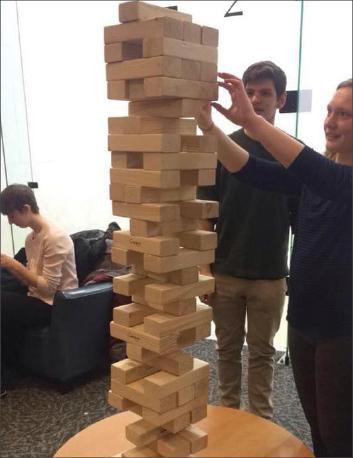 Students build a giant Jenga tower at the Ray Meyer Fitness Center and Recreation Thursday for Retro Sports Night. (Photo courtesy of Alyssa McHugh)