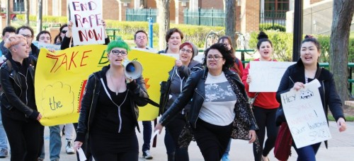(From left) Laura Springman, Kara Rodriguez and Adina Babaian lead DePaul’s annual Take Back the Night march Thursday. (Erin Yarnall / The DePaulia)