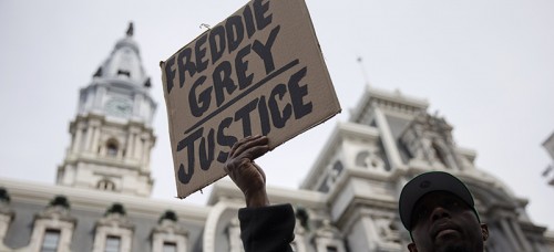 A demonstrator outside City Hall in Philadelphia on April 30. The event in Philadelphia follows days of unrest in Baltimore after Freddie Gray's police-custody death. (AP Photo/Matt Rourke)