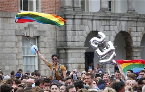 Yes supporters celebrate at Dublin castle, Ireland, Saturday, May 23, 2015. Ireland has voted resoundingly to legalize gay marriage in the world's first national vote on the issue, leaders on both sides of the Irish referendum declared Saturday even as official ballot counting continued. Senior figures from the "no" campaign, who sought to prevent Ireland's constitution from being amended to permit same-sex marriages, say the only question is how large the "yes" side's margin of victory will be from Friday's vote. (AP Photo/Peter Morrison)