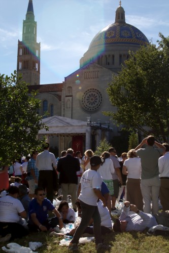 Attendees wait for the evening Mass to start on the lawn of the Basilica of the National Shrine Wednesday. Some were at the site to claim spots in the early morning. (Megan Deppen / The DePaulia)