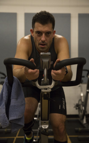 Ben Varble completes the cycling portion of the DePaul Indoor Triathlon. Each participant completes 10 minutes of swimming, 30 minutes of cycling, and 20 minutes of running. (Geoff Stellfox / The DePaulia)