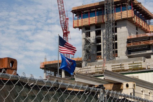 A DePaul flag flies above the construction site of the DePaul arena. (Megan Deppen / The DePaulia)