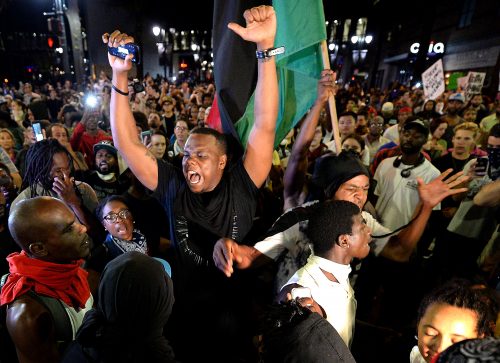 Protesters celebrate their arrival at Trade and College Streets in Charlotte, N.C., on Thursday, Sept. 22, 2016, as demonstrations continue following the shooting death of Keith Scott by police earlier in the week. (Jeff Siner/Charlotte Observer/TNS)
