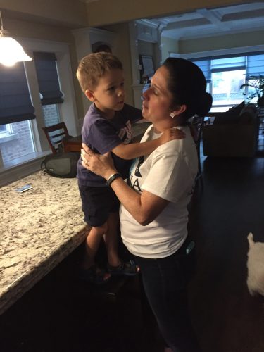 Mendoza plays with her son in her Portage Park home. (Brenden Moore/The DePaulia)