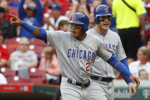 Addison Russell celebrates a run in a game against the Reds in September. (John Minchillo/AP)
