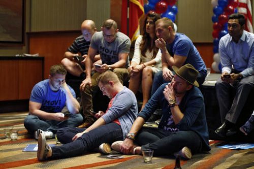 Democratic supporters of Hillary Clinton check results as Donald Trump began to pick up wins in key states, while watching results come in at the Dallas County Democrats party at Hyatt Regency in Dallas, Texas, late on Tuesday, Nov. 8, 2016. (Nathan Hunsinger/The Dallas Morning News via AP)