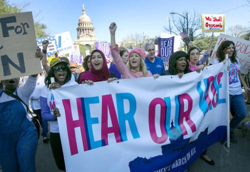 Former Texas State Senator Wendy Davis, center, dressed in pink, leads the women's movement at the Women's March on Austin to stand up for women's rights, Saturday, jan. 21, 2017, in Austin, Texas. In a global exclamation of defiance and solidarity, more than 1 million people rallied at women's marches in the nation's capital and cities around the world Saturday to send President Donald Trump an emphatic message on his first full day in office that they won't let his agenda go unchallenged. (Ralph Barrera/Austin American-Statesman via AP)