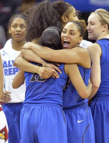 DePaul's Jessica January (14) hugs Chanise Jenkins following their win over Louisville in a second-round women's college basketball game in the NCAA Tournament in Louisville, Ky., Sunday, March 20, 2016. (AP Photo/Timothy D. Easley)