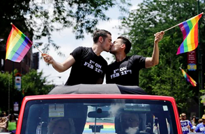 Charlie Gurion, left, kisses David Wirk at the 45th Annual
Chicago Pride Parade during the parade on Broadway Street
Sunday, June 29, 2014. The event, the first since Illinois law
allowing same-sex marriage went into effect, has 200 registered
entrants, with about 1 million expected to participate.
(AP Photo/Nam Y. Huh)