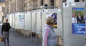 Women check electoral boards for the European elections, in Paris, Friday, May 16. (AP Photo)