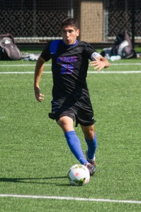 DePaul forward Art Garza goes back to kick the ball. (Grant Myatt / The DePaulia)