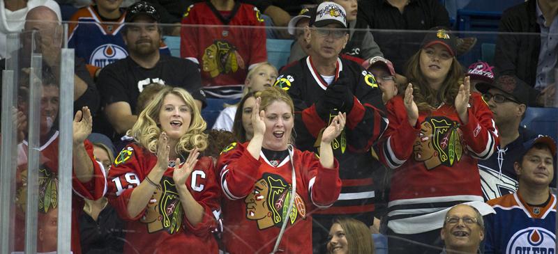 Chicago Blackhawks fans celebrate a goal against the Edmonton Oilers in preseason action. (Liam Richards / AP)