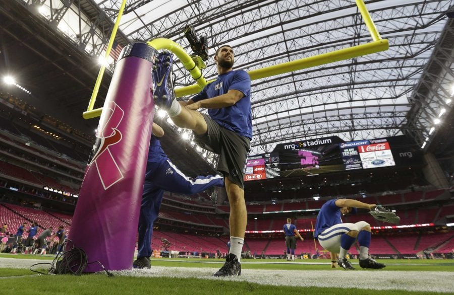  Indianapolis Colts' quarterback Andrew Luck leans on a goalpost as he stretches before a game against the Houston Texans, Oct. 9, in Houston. The NFL celebrates Breast Cancer Awareness Month by “pinking” stadiums and select equipment. Photo courtesy David Phillips/AP