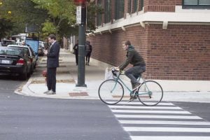 A biker riding down Fullerton Avenue. Many students use biking as a way to get around campus. Photo by Carlyn Duff/The DePaulia