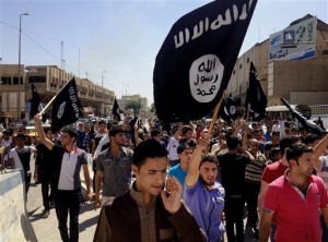 New recruits of ISIS march through Mosul, Iraq. The militant group has recruited some people  internationally through the use of high-tech recruiting videos. Photo courtesy AP.