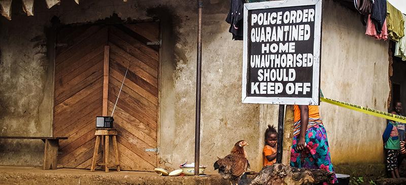 This sign stands outside a family home that has been placed under quarantine because of the Ebola virus in Port Loko, Sierra Leone. (Michael Duff | AP)