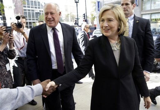 Former U.S. Secretary of State Hillary Rodham Clinton, right, and Illinois Gov. Pat Quinn, left, talk with supporters  as they arrive at a Barnes & Noble bookstore in Chicago Wednesday, Oct. 8, 2014. Clinton visited Chicago for two appearances, including a speech to a business group, and she is expected to stump for Quinn in his bid for re-election. (AP Photo/ Nam Y. Huh)