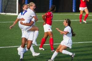 The women’s soccer team celebrates a goal at the beginning of their season. (Grant Myatt / The DePaulia)