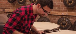 Graduate student Nick Bonnacci tunes the timpani drum. (Maggie Gallagher / The DePaulia)