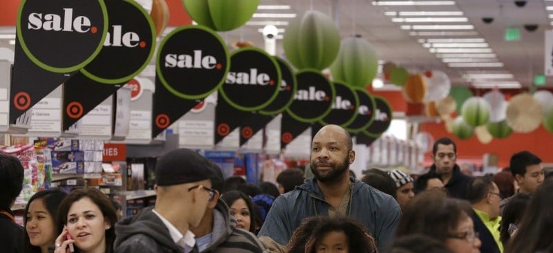 In this Nov. 28, 2013 file photo, customers shop at a Target store in Colma, Calif. Experts say Thanksgiving weekend lives up to the hype of serving up the best bargains of the year from TVs to clothing. Shoppers, however, need to do their homework before joining the crowds at the mall or heading online for the official kickoff thats increasingly creeping into the turkey feast. (AP Photo/Jeff Chiu, File)