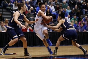 DePaul guard Brittany Hrynko (12) pushes through Notre Dame forward Kathryn Westbeld, left, and guard Mychal Johnson, right, during the second half of an NCAA college basketball game on Wednesday, Dec. 10, 2014, in Chicago. (AP Photo/Andrew A. Nelles)