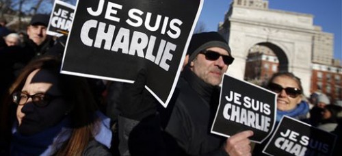 Attendees hold "Je suis Charlie" (I am Charlie) signs as several hundred people gather in solidarity with victims of two terrorist attacks in Paris on Jan. 10. (Jason Decrow | AP)