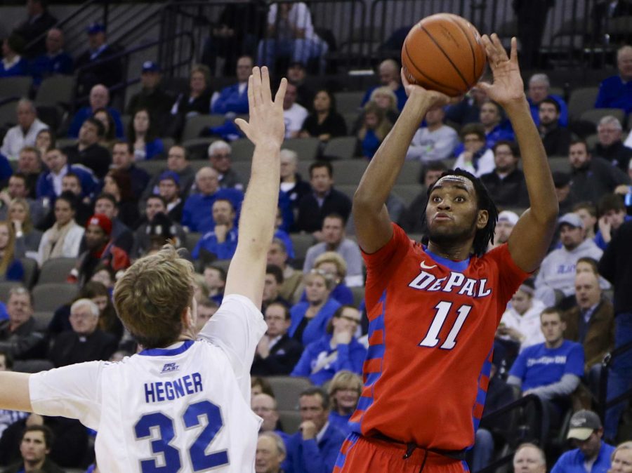 DePaul's Forrest Robinson (11) shoots a 3-pointer over Creighton's Toby Hegner during the first half of an NCAA college basketball game in Omaha, Neb., Wednesday, Jan. 7, 2015. (AP Photo/Nati Harnik)