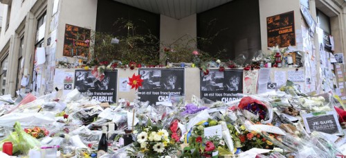 Flowers lay outside Charlie Hebdo headquarters in Paris, France on Jan. 14 after the terrorist attack. Since then, 54 people have been arrested for hate speech and anti-Semitism. (Jacques Brinon | AP)