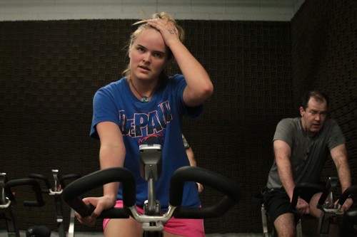 Senior Claire Edlund fought the burn during the 30-minute bicycle portion of DePaul’s first indoor triathlon. (Megan Deppen / The DePaulia)