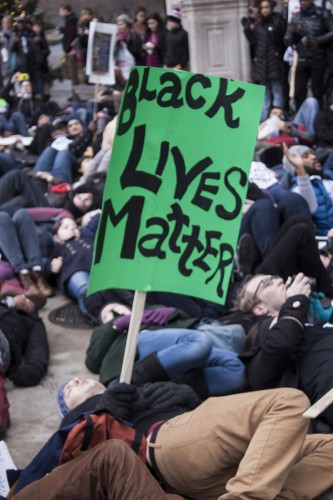 People participate in a "die-in" during the march. (Kevin Gross / The DePaulia)