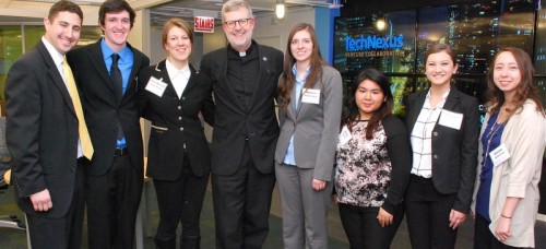 Rev. Dennis H. Holtschneider (center) poses with (L-R) Adam H. Grossman, David Allen, Sue Nicole Susenburger, Monica Grygorowiz, Jenny Fuerte, Morgan Schulhof, and Elaine Ackerman, the winners at the DePaul Student Innovation Awards. (Photo courtesy of Kathy Hillegonds at the Driehaus College of Business)