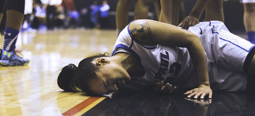 DePaul senior guard Brittany Hyrnko lays on the ground after a hard hit in Friday’s game against Seton Hall at McGrath-Phillips Arena. The Blue Demons went on to lose 81-80. (Josh Leff / The DePaulia)
