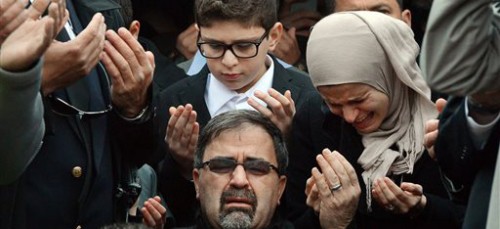 The family of Deah Shaddy Barakat mourns at his funeral. Barakat was one of three Muslims murdered on Feb. 10 in Chapel Hill, N.C. (AP Photo/The News Observer, Chuck Liddy)