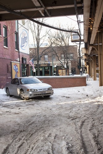 Many parking lots, such as this lot at Kelly's Pub, remain poorly plowed. Industry insiders say factors like this can impact profits. (Kevin Gross / The DePaulia)