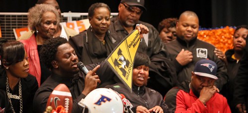 East St. Louis High School defensive lineman Terry Beckner Jr., second from left, announces intentions to attend Missouri during national signing day, Feb. 4, 2015. (Chris Lee | AP)