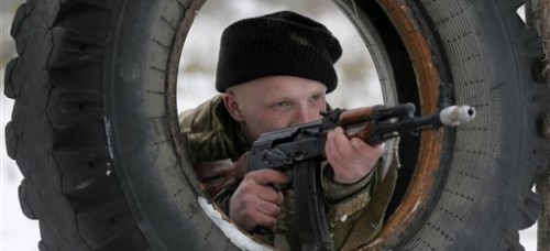 A Ukrainian soldier takes aim at targets. Before the ceasefire, fighting had taken a heavy toll on Eastern Ukraine. (AP Photo/Efrem Lukatsky)