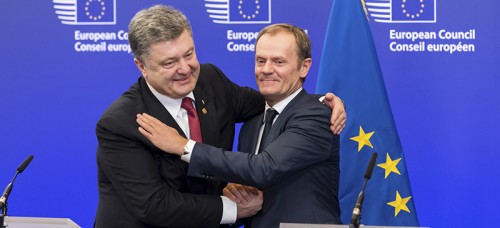 Ukrainian President Petro Poroshenko (left) and European Council President Donald Tusk embrace during the negotiation of a ceasefire between Russia and the Ukraine. (AP Photo/Geert Vanden Wijngaert)