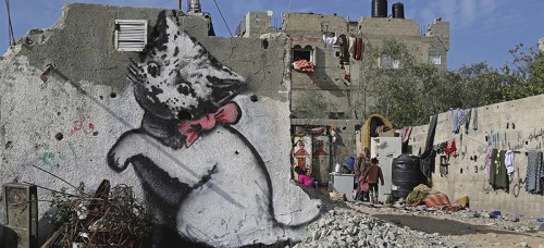 A Banksy-produced mural sits amid rubble in the Gaza Strip. (Adel Hana | AP)