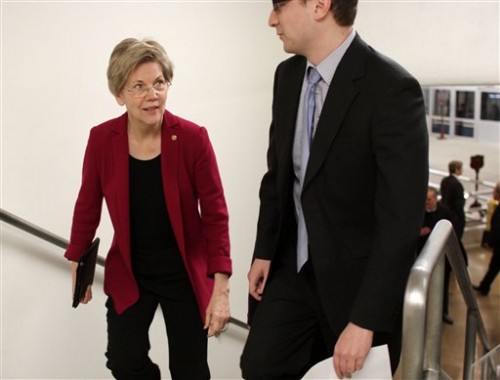 Sen. Elizabeth Warren, D-Mass. speaks to a staff member on Capitol Hill in Washington Feb. 25 as Democrats and Republicans headed to their party caucus meetings to discuss the homeland security funding.  (AP Photo/Lauren Victoria Burke)