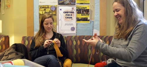 Sophomore Julia Dougarian and director Katie Sullivan knit pieces during a meeting of Crafting for a Cause. A subgroup of Catholic Campus Ministry, the group meets weekly as both an opportunity to share in their love of crafting and to give back to the community. Many of their blankets and scarves are donated to the needy, sometimes through the St. Vincent DePaul Center. (Emily Brandenstein / The DePaulia)