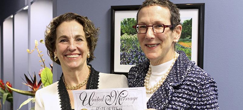Suzanne Bryant (left) and Sarah Goodfriend hold up their marriage license after a press conference Feb. 19. They became the first same-sex couple to marry in Texas on Thursday morning. (Mariana Munoz | AP)