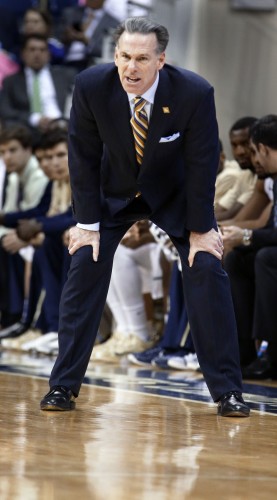 Pittsburgh head coach Jamie Dixon looks down the court as his team plays against George Washington in the first half of the NCAA college basketball game in the first round of the NIT Tournament on Tuesday, March 17, 2015, in Pittsburgh. George Washington won 60-54 to advance to the second round of the tournament. (AP Photo/Keith Srakocic)