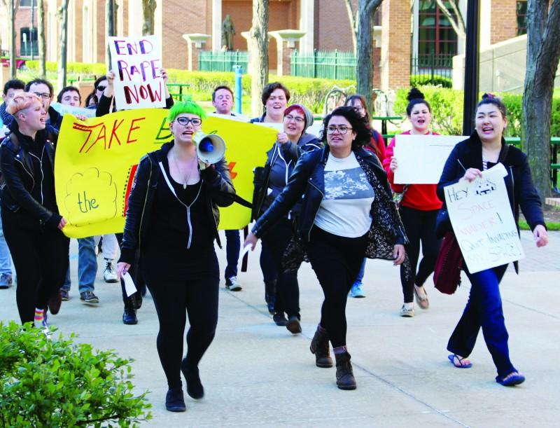 (From left) Laura Springman, Kara Rodriguez and Adina Babaian lead DePaul’s annual Take Back the Night march Thursday. (Erin Yarnall / The DePaulia)