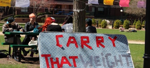 DePaul’s Feminist Front sits with a symbol of sexual assault on campuses and invites passerby to hangout. (Megan Deppen / The DePaulia)