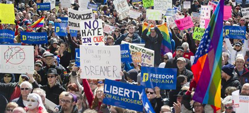 Numerous efforts, ranging from pro-LGBT protests (left) to the sending of letters to Indiana politicians, preceded the amendment of  Indiana's Religious Freedom Restoration Act. (AP Photo/Doug McSchooler)