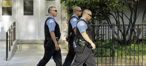 Beat police patrol the streets of Chicago. Many pundits question whether increased police presence is a socially or economically effective method to fight crime. (AP Photos/M. Spencer Green)