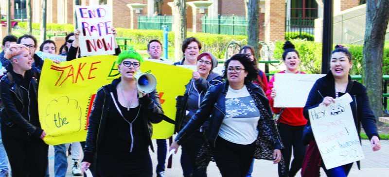 Protesters march Thursday evening in the annual Take Back the Night rally. (Erin Yarnall/The DePaulia)